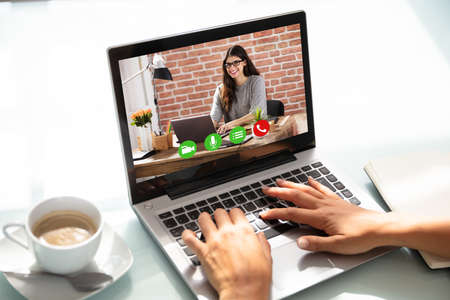 Businesswoman Video Conferencing With Her Female Partner On Laptop
