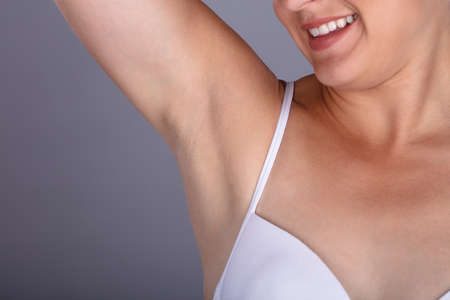 Close-up Of A Woman Showing Clean Underarms On Grey Backgroundの写真素材