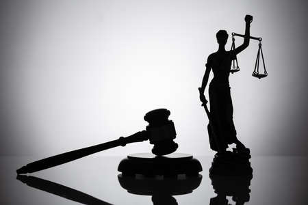 Statue Of Justice And Gavel On Reflective Backgroundの写真素材