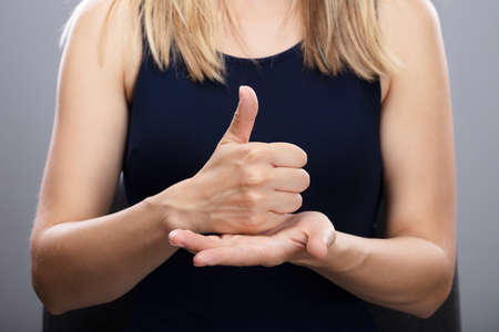 Close-up Of A Woman's Hands Using Sign Language