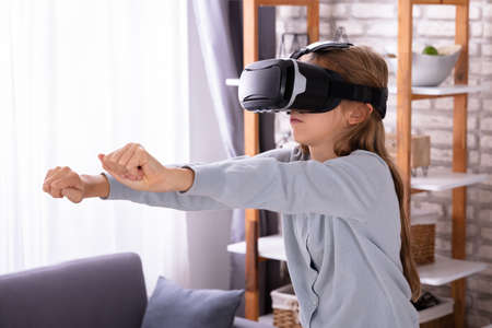 Side View Of A Girl Using Virtual Reality Headset At Home