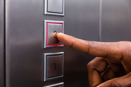 Close-up Of A Man's Finger Pressing On Second Floor Elevator Button