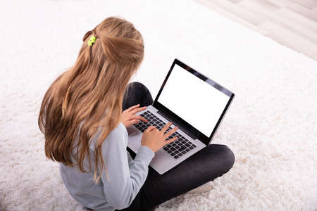 Girl Using Laptop With Blank White Screen