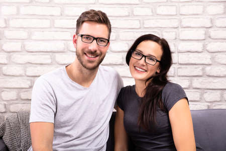 Portrait Of A Happy Young Couple Wearing Eyeglassesの写真素材