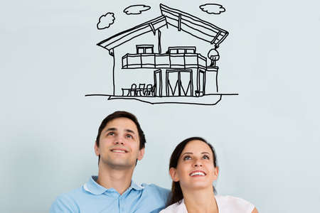 Close-up Of A Happy Young Couple Thinking Of Buying Their New Houseの写真素材