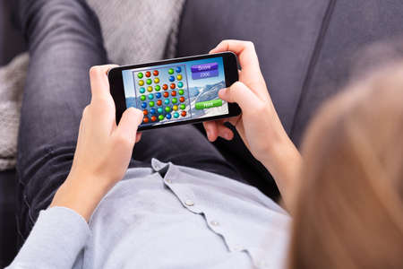 Close-up Of A Girl's Hand Playing Game On Mobile Phone
