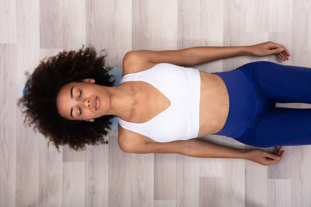 High Angle View Of A Young Woman Doing Workout On Exercise Mat