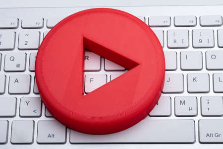 An Elevated View Of Red Play Button On White Keyboard