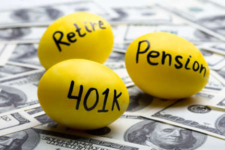 Pension And Retire Text On Yellow Eggs Over Hundred Dollar Note