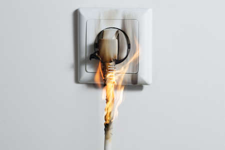 Electric Short Circuit Causing Fire On Plug Socket At Homeの写真素材
