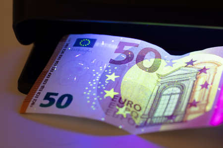 Detector Banknotes And Money On White Background