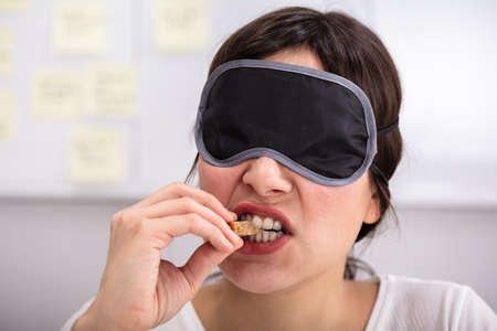 Portrait Of Blindfolded Young Woman Testing Food