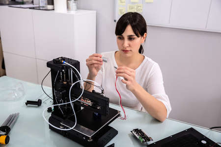 Smiling Confident Female Electrician Repairing Hardware Part