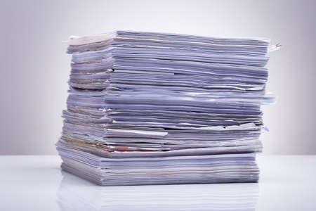 Photo Of Stacked Document Paper On Reflecting Backdrop