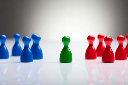Close-up Of Colorful Pawns On The Reflective Desk Against Gray Backgroundの写真素材