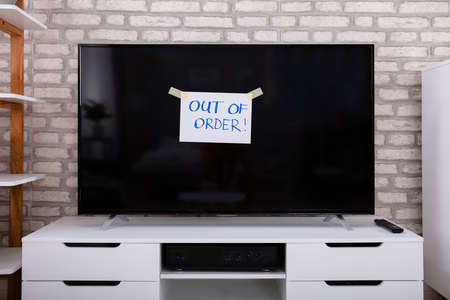 Out Of Order Text On Blank Screen Television In Living Roomの写真素材