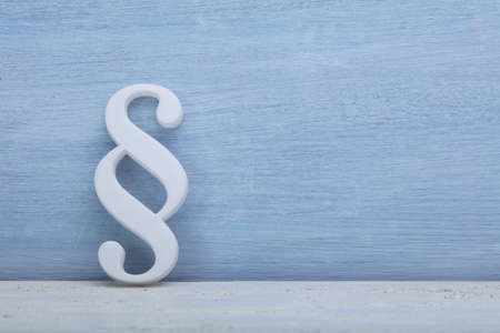 Close-up Of A Paragraph Symbol Leaning On Blue Wall
