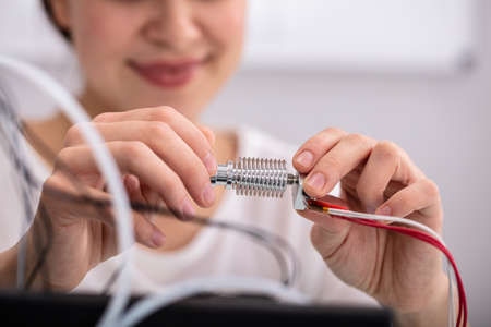 Smiling Confident Female Electrician Repairing Hardware Part
