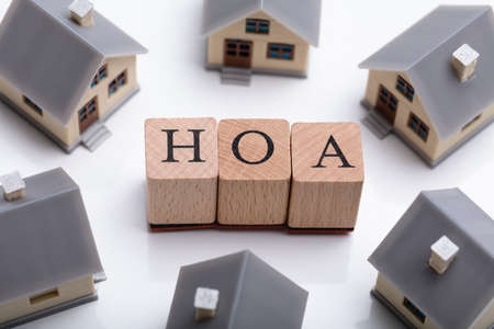 House Models Around HOA Cubic Blocks Over Reflective Deskの写真素材