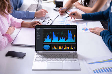 Close-up Of Male And Female Businesspeople In Meeting Discussing Graphs