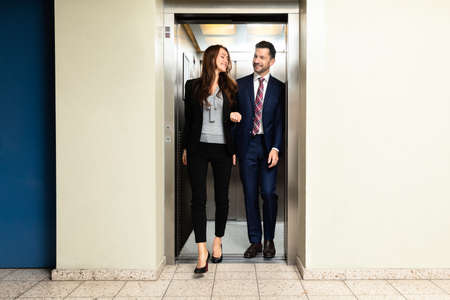 Happy Young Couple Coming Out From An Elevatorの写真素材