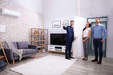 Happy house agent Showing New Modern House To Customersの写真素材