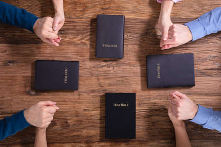 Close-up Of People Holding Each Others Hand Praying Together