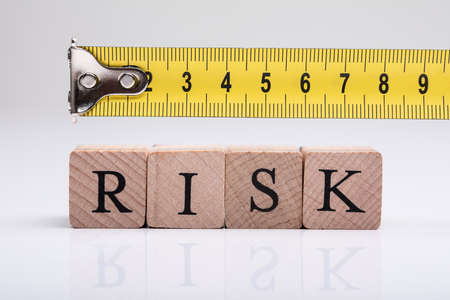 Yellow Measuring Tape Over The Wooden Risk Blocks