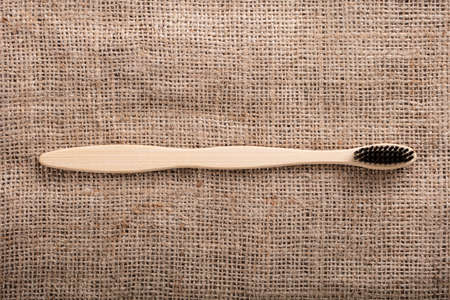 Close-up Of Black Bamboo Toothbrush On Sack Clothの写真素材