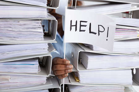 Businesswoman Holding White Help Flag With Stack Of Folders
