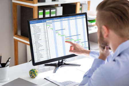 Businessman Working On Gantt Chart At Office