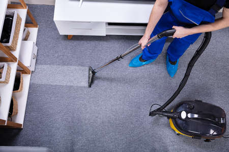 Male Janitor Using Vacuum Cleaner Janitor Cleaning Carpet With Vacuum