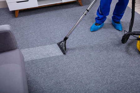 Male Janitor Cleaning Carpet Janitor Cleaning Carpet With Vacuum