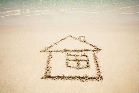 Close-up Of Hand Drawn House Near The Idyllic Sea On The Beachの写真素材