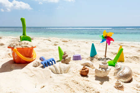 Plastic Toys And Seashells On Sand At Beachの写真素材