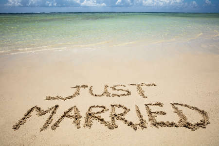 Just Married Written Text On Sand Near The Idyllic Sea At Beachの写真素材