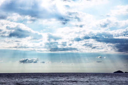 Scenic View Of Sunlight Streaming In The Sky Over The Seascapeの写真素材
