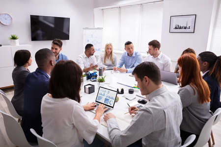 Group Of Multi Ethnic Business Team Sitting Together At Workplace In Modern Office