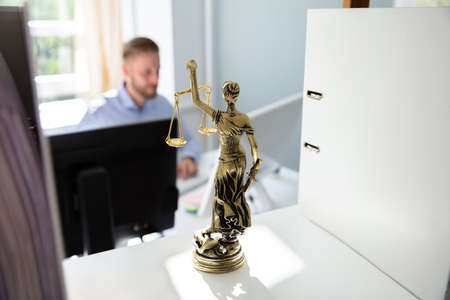 Justice Statue On Shelf And Lawyer Working In Office At backgroundの写真素材