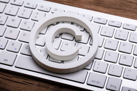 Elevated View Of White Copyright Symbol On Computer Keyboardの写真素材