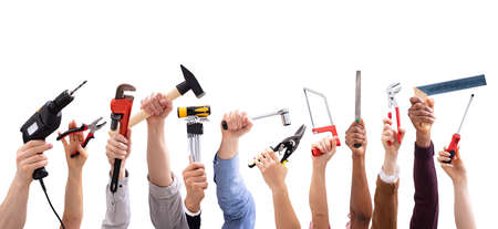 Close-up Of People's Hand Holding Carpentry Tools Against White Backgroundの写真素材