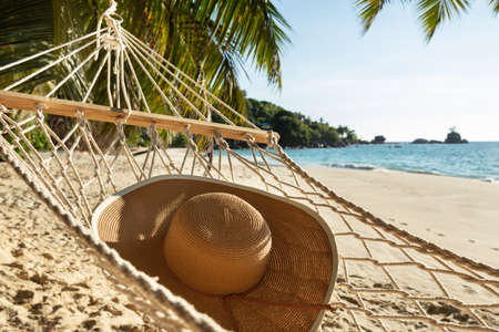 Close-up Of Sun Hat On Hammock Over The Sand At Beachの写真素材