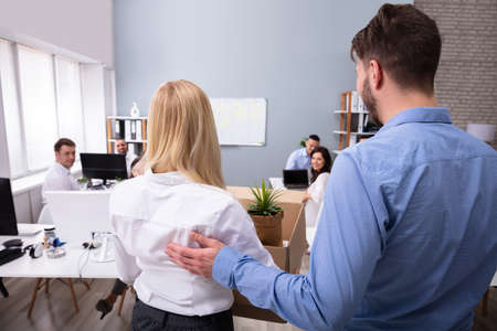 Smiling Young Manager Welcoming New Female Employee Introducing Her To Old Colleagues At Workplace