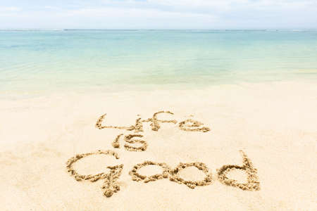 Close-up Of Life Is Good Word Written On The Sand At Idyllic Beachの写真素材
