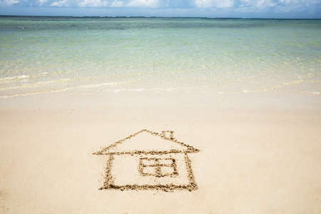 Close-up Of Hand Drawn House Near The Idyllic Sea On The Beachの写真素材