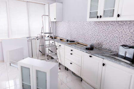 Installation Of White Cabinet With Tools And Ladder In The New Modular Houseの写真素材