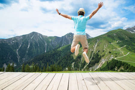 Happy Man Jumping In Austrian Mountains In Summerの写真素材