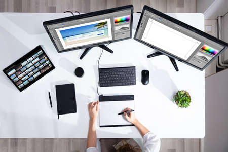 Female Editor Working With Photos On Computerの写真素材