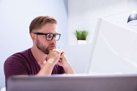 Close-up Of Contemplated Businessman Looking At Computer