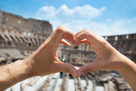 Couple Making Heart Shape In Inside Of Colosseum, Italyの写真素材